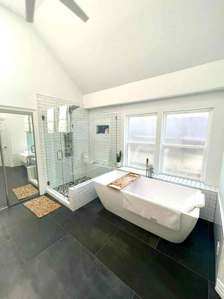 Master bathroom remodeling Southlake TX tub walk-in shower with subway tile pebble mosaic floor vaulted ceiling and large format dark floor tile by I Love My Bathroom
